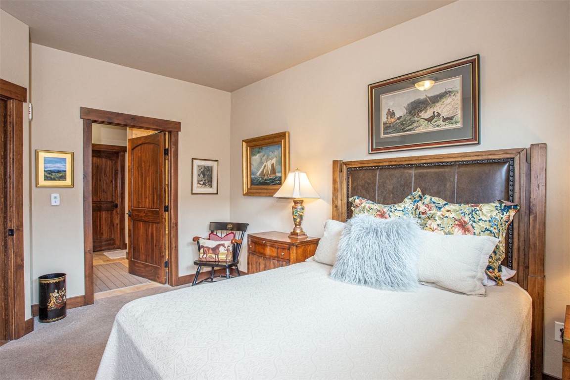 421 Rainbow Drive, Unit 5 Silverthorne, CO 80498 - Photo 21 of 36 a bed room with a bed and a painting on the wall