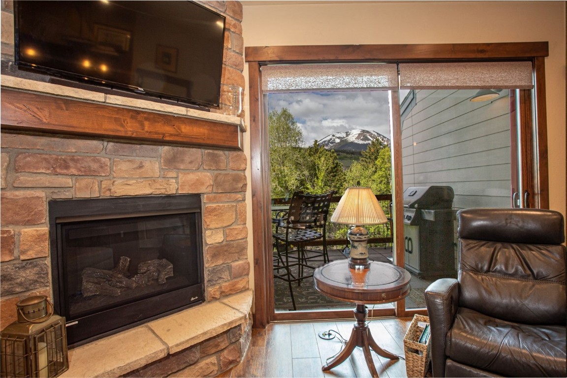 421 Rainbow Drive, Unit 5 Silverthorne, CO 80498 - Photo 7 of 36 a living room with furniture a flat screen tv and a fireplace