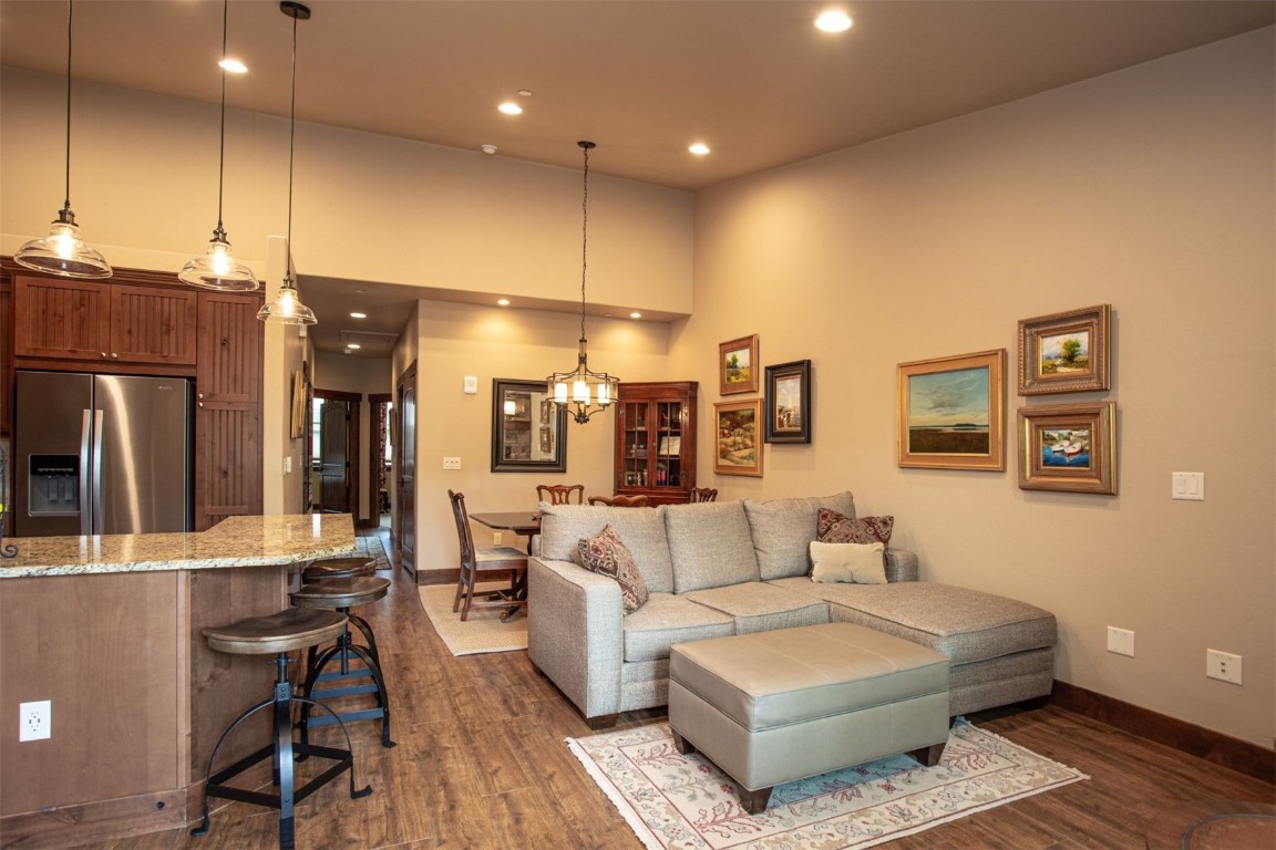 421 Rainbow Drive, Unit 5 Silverthorne, CO 80498 - Photo 9 of 36 a living room with couches and kitchen view with wooden floor
