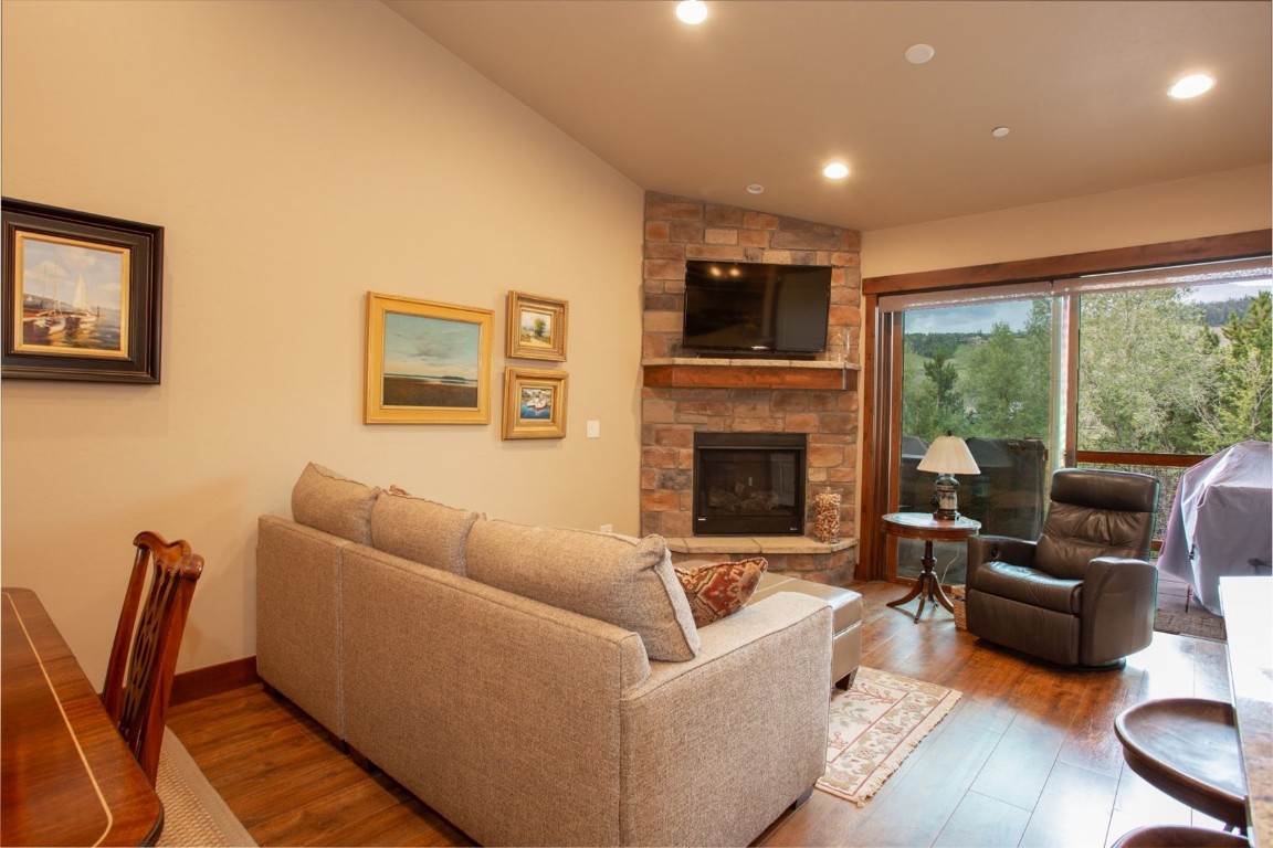 421 Rainbow Drive, Unit 5 Silverthorne, CO 80498 - Photo 10 of 36 a living room with furniture a flat screen tv and a fireplace