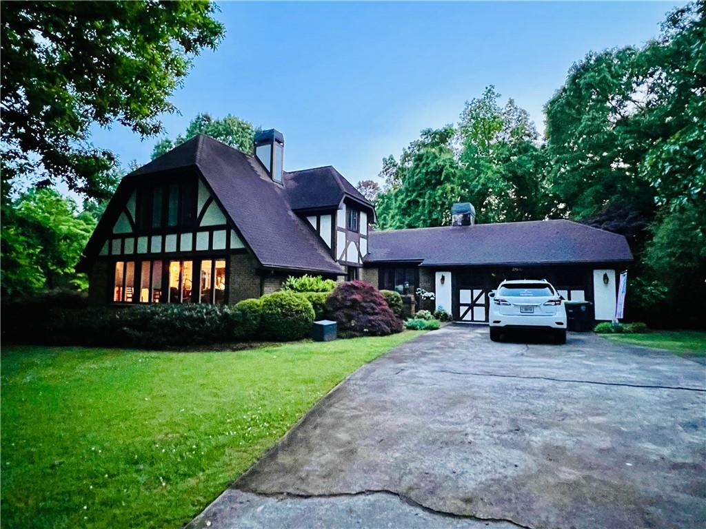 206 Saddle Mountain Road Southeast Rome, GA 30161 - Photo 1 of 1 a front view of a house with garden