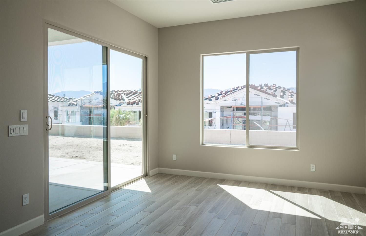 15 Riesling Rancho Mirage, CA 92270 - Photo 11 of 17 a view of an empty room with wooden floor and a window
