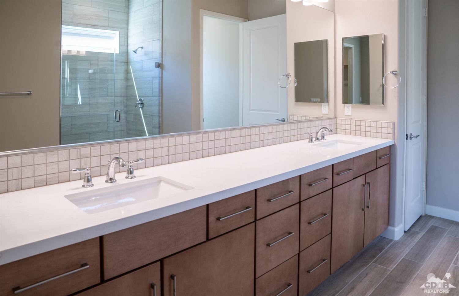 15 Riesling Rancho Mirage, CA 92270 - Photo 15 of 17 a bathroom with a double vanity sink and mirror