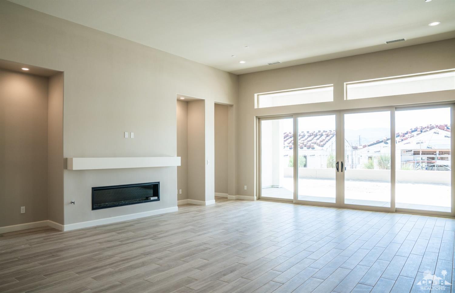 15 Riesling Rancho Mirage, CA 92270 - Photo 4 of 17 a view of empty room with wooden floor and fireplace