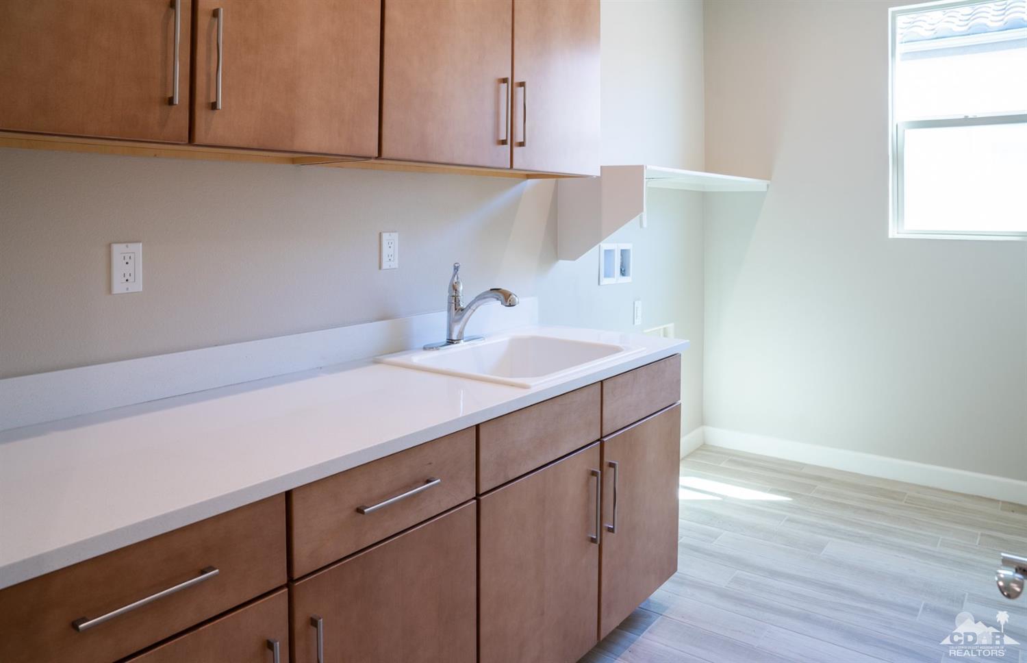 15 Riesling Rancho Mirage, CA 92270 - Photo 5 of 17 a kitchen with a sink cabinets and a window