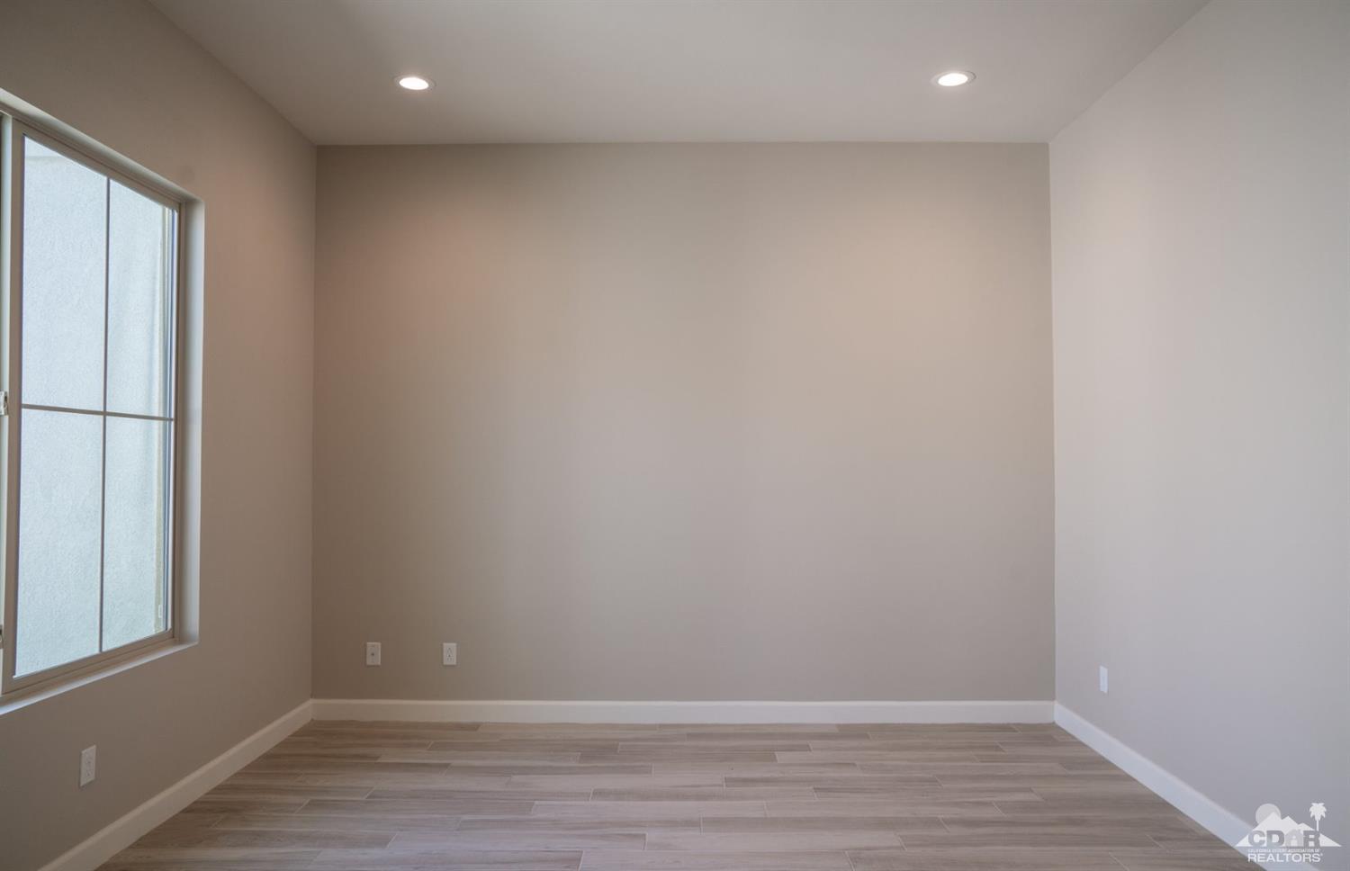 15 Riesling Rancho Mirage, CA 92270 - Photo 10 of 17 a view of room with window and wooden floor