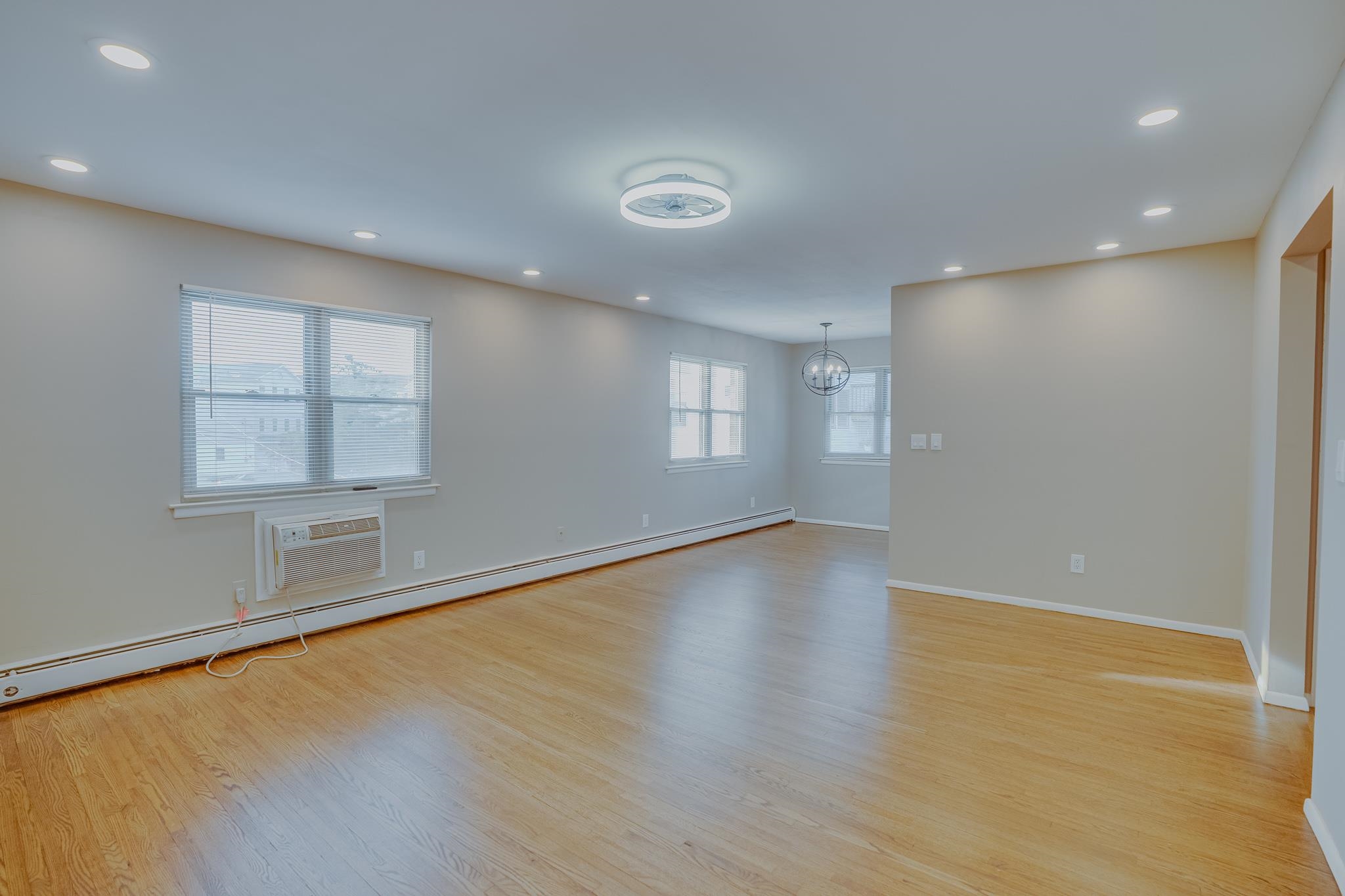 1138F Farm Road, Unit D Secaucus, NJ 07094 - Photo 2 of 10 an empty room with wooden floor and windows