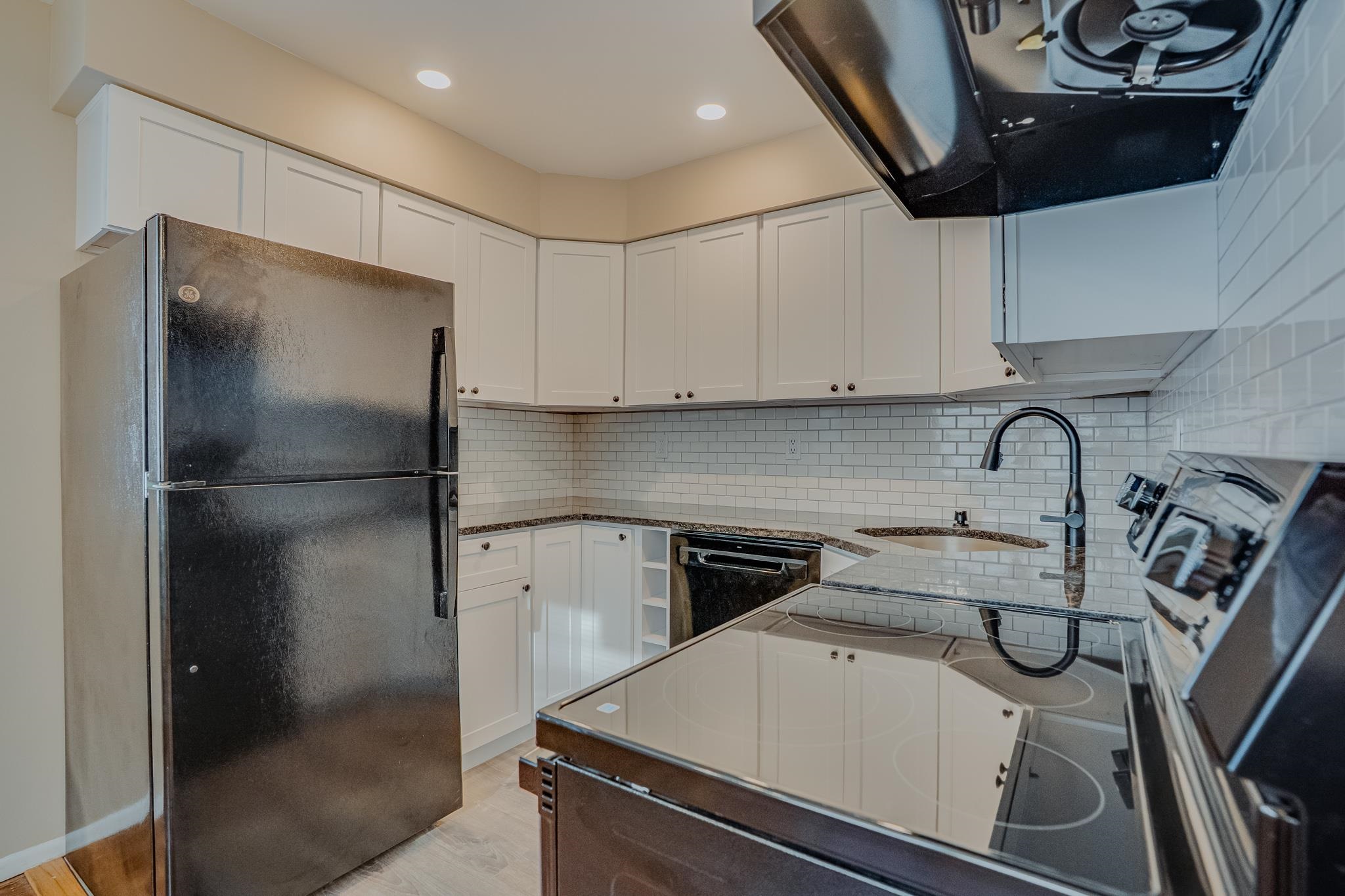 1138F Farm Road, Unit D Secaucus, NJ 07094 - Photo 3 of 10 a kitchen with a refrigerator and a sink