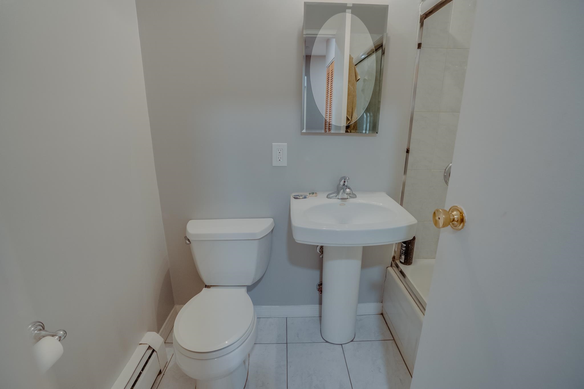 1138F Farm Road, Unit D Secaucus, NJ 07094 - Photo 7 of 10 a bathroom with a toilet sink and mirror