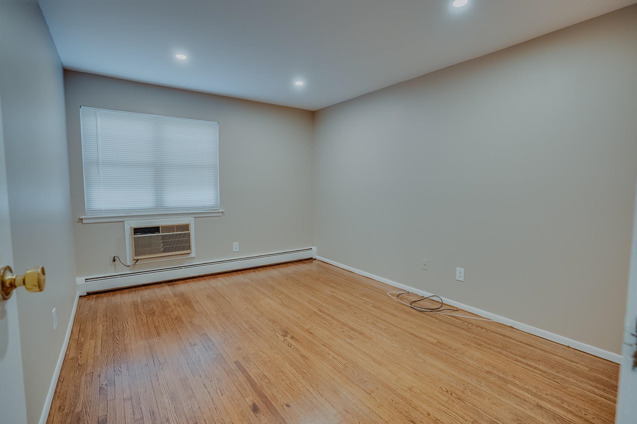 1138F Farm Road, Unit D Secaucus, NJ 07094 - Photo 9 of 10 a view of empty room with wooden floor and fan