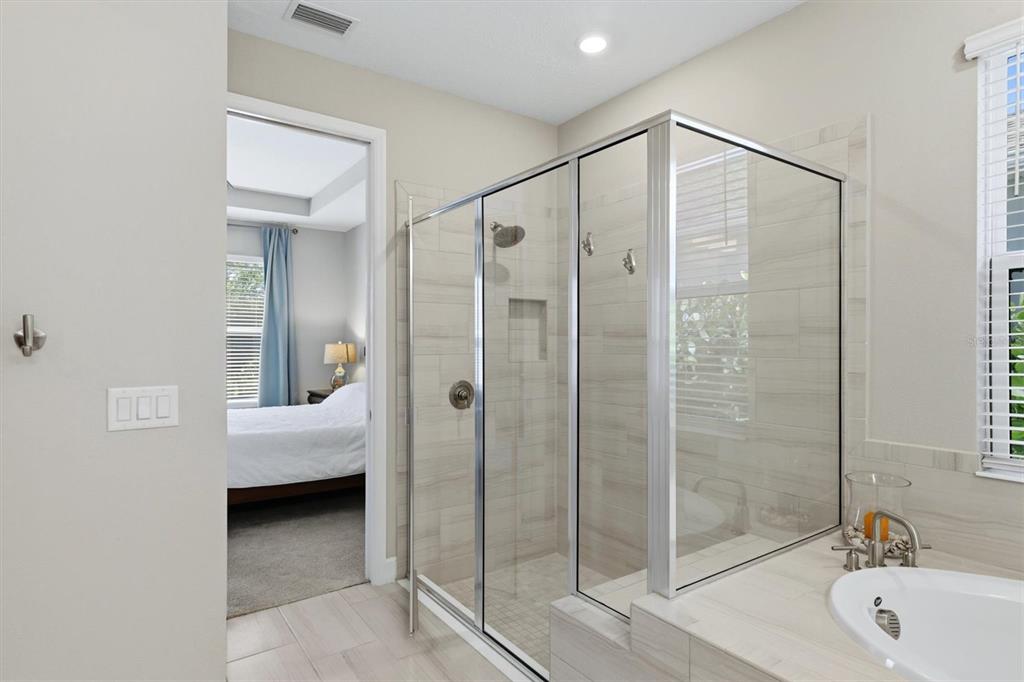 9268 Tequila Sunrise Drive Sarasota, FL 34241 - Photo 23 of 56 a bathroom with a bathtub and a shower