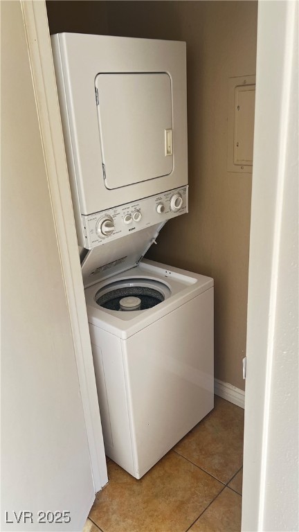 1486 Elizabeth Avenue, Unit 1 Las Vegas, NV 89119 - Photo 27 of 34 Laundry area with light tile patterned floors and estacked washer and dryer