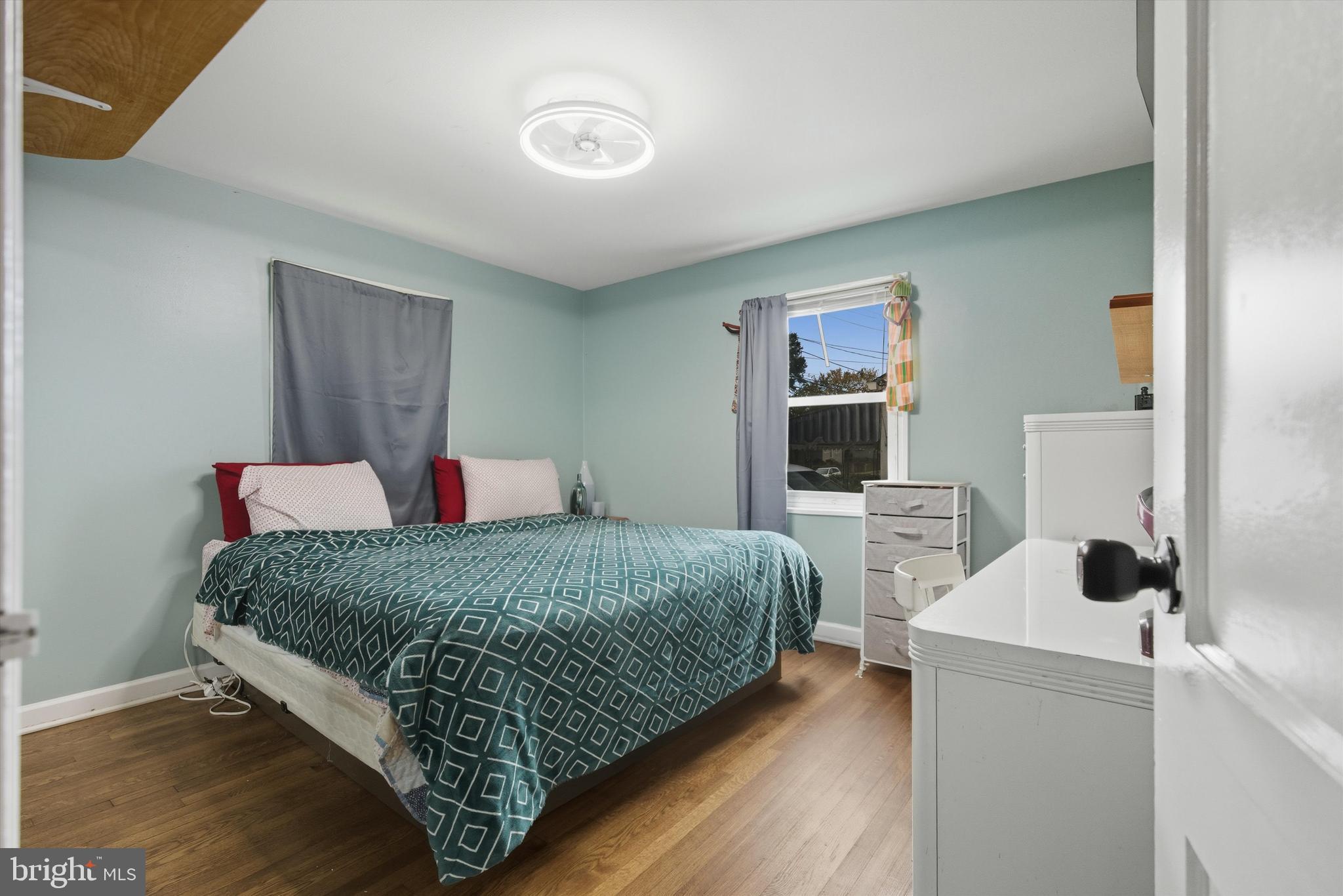 5024 Addison Road Capitol Heights, MD 20743 - Photo 13 of 23 a bedroom with a bed and a flat screen tv