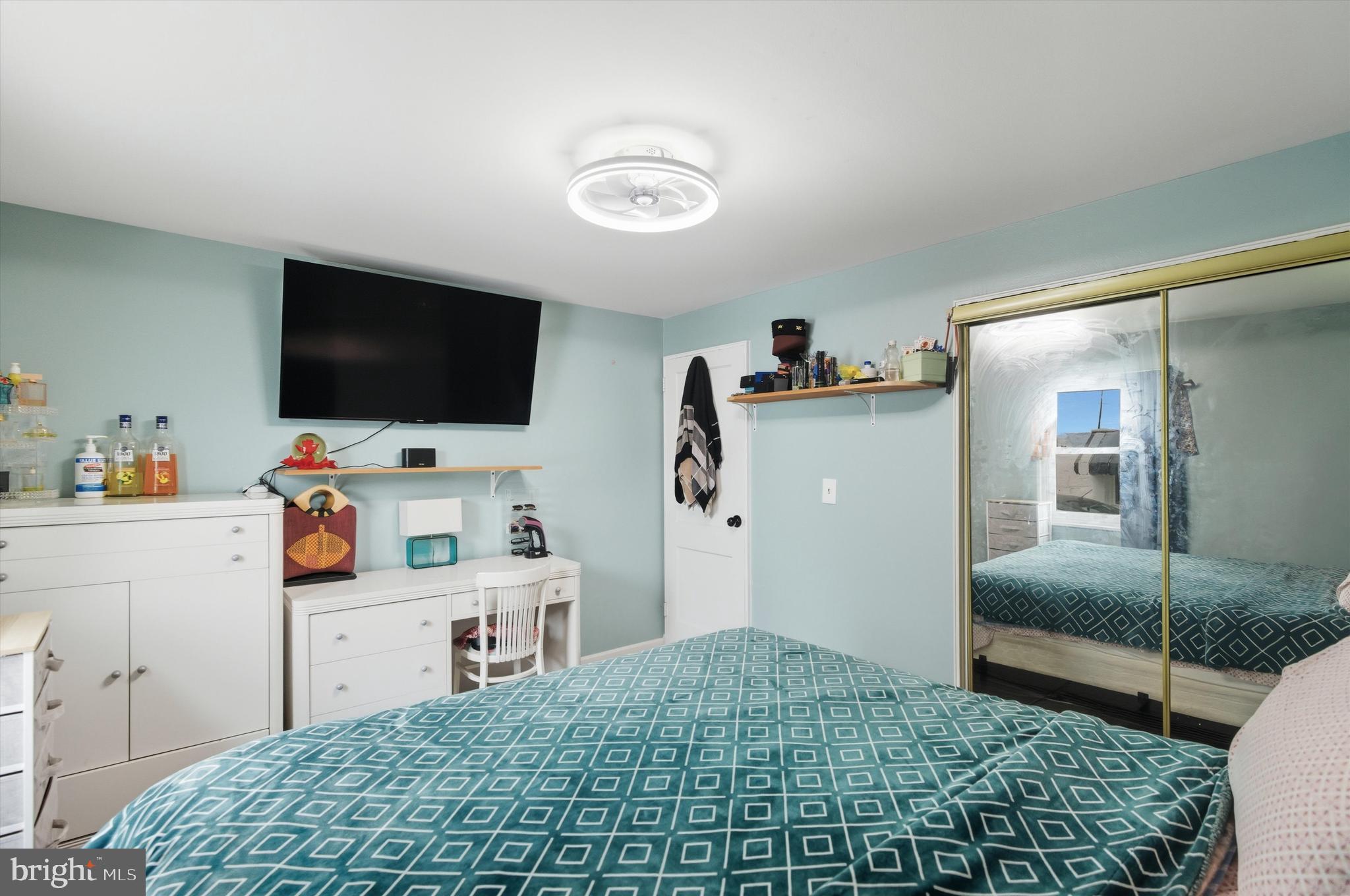 5024 Addison Road Capitol Heights, MD 20743 - Photo 14 of 23 a bedroom with a bed and flat screen tv