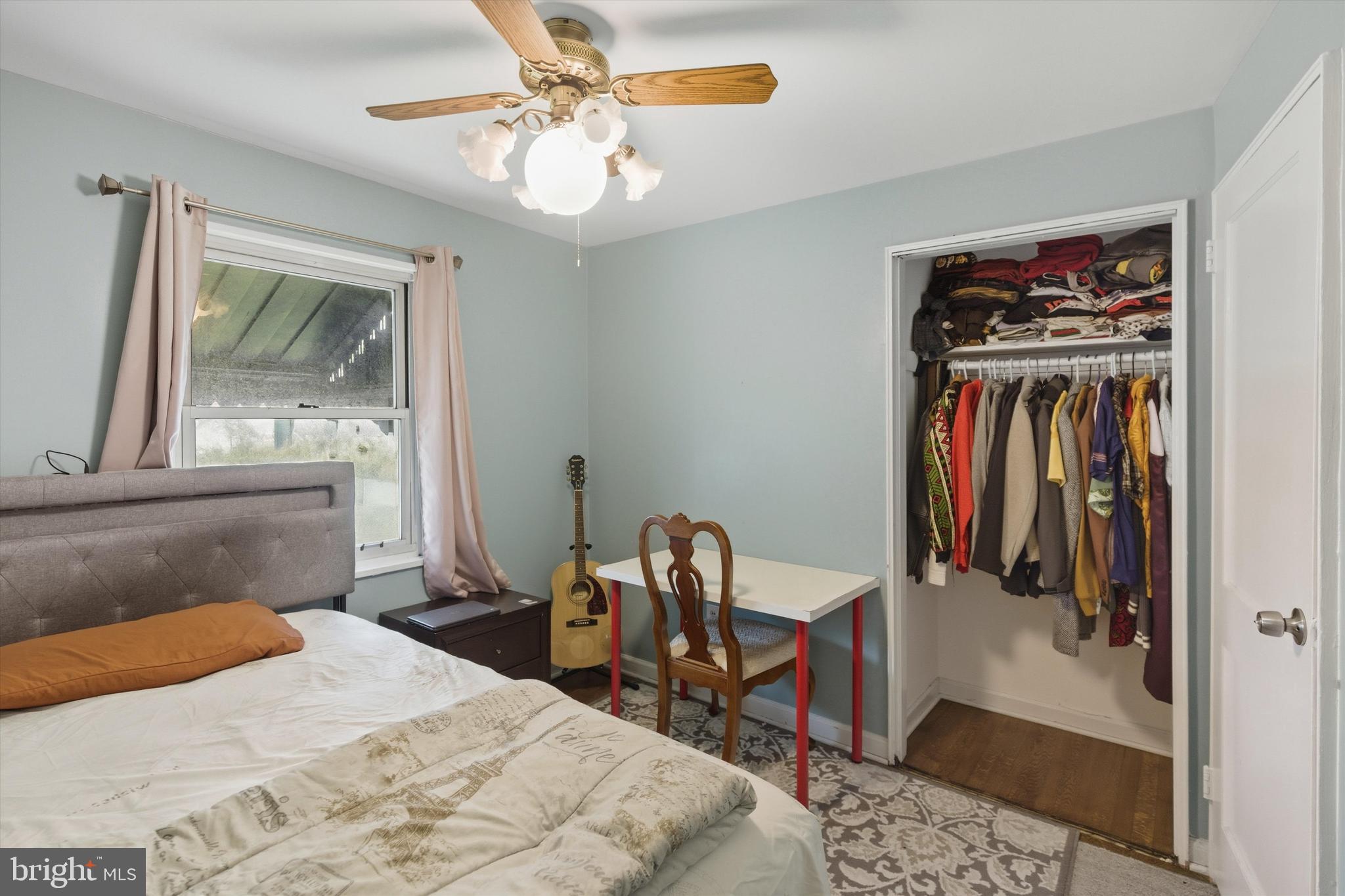 5024 Addison Road Capitol Heights, MD 20743 - Photo 19 of 23 a bedroom with a bed and a chandelier