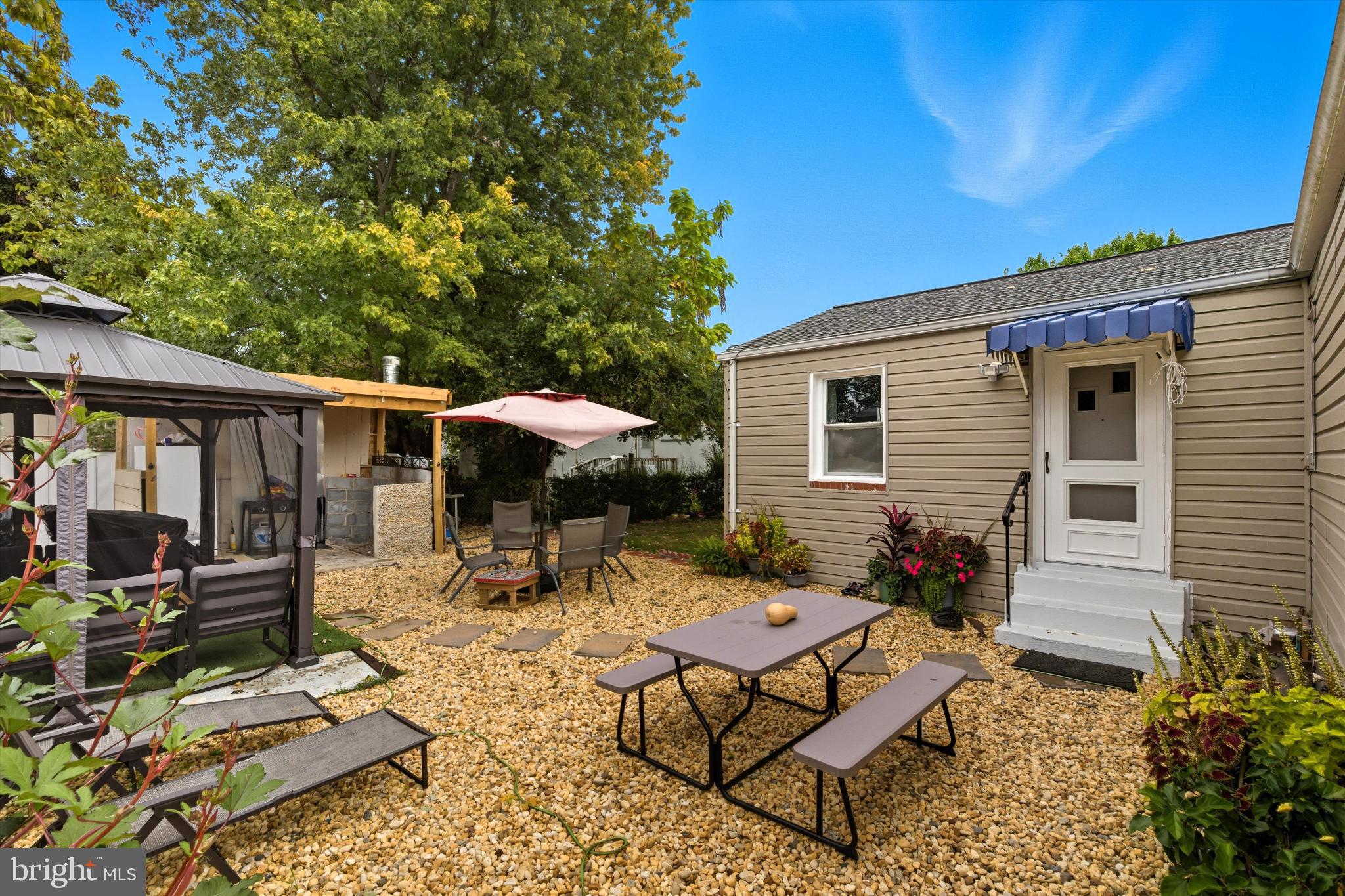 5024 Addison Road Capitol Heights, MD 20743 - Photo 20 of 23 a backyard of a house with barbeque oven table and chairs