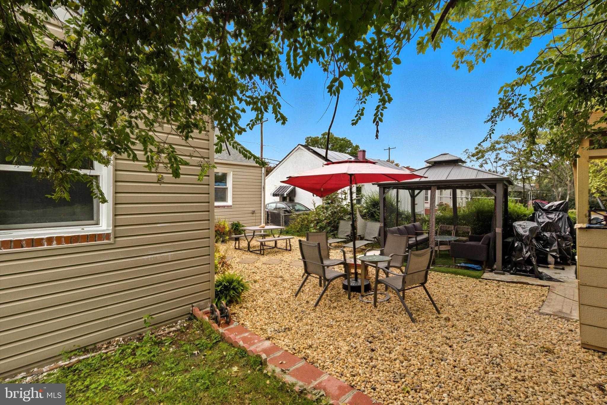 5024 Addison Road Capitol Heights, MD 20743 - Photo 21 of 23 a view of a patio with a table and chairs under an umbrella