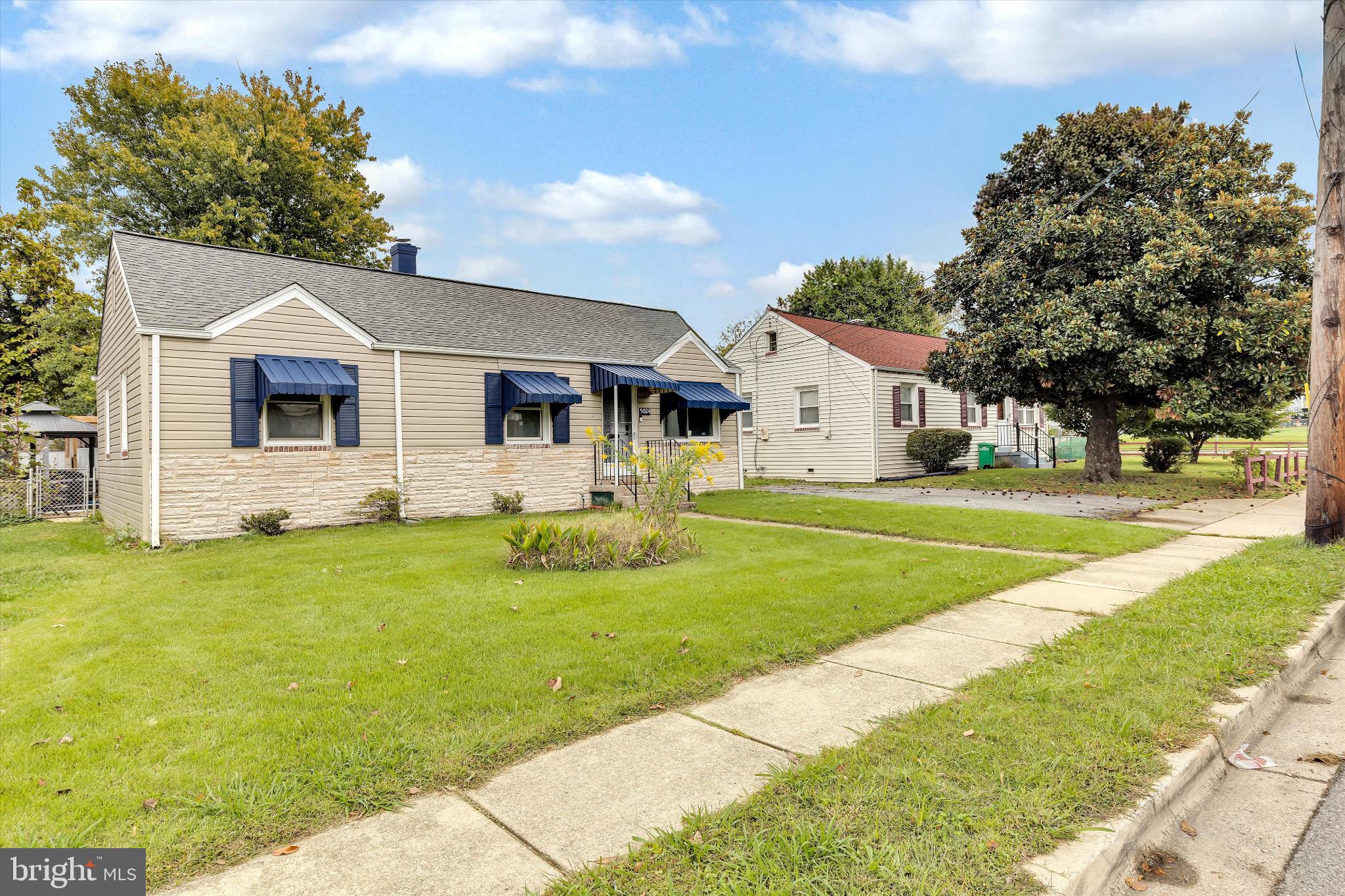 5024 Addison Road Capitol Heights, MD 20743 - Photo 3 of 23 a front view of a house with a yard