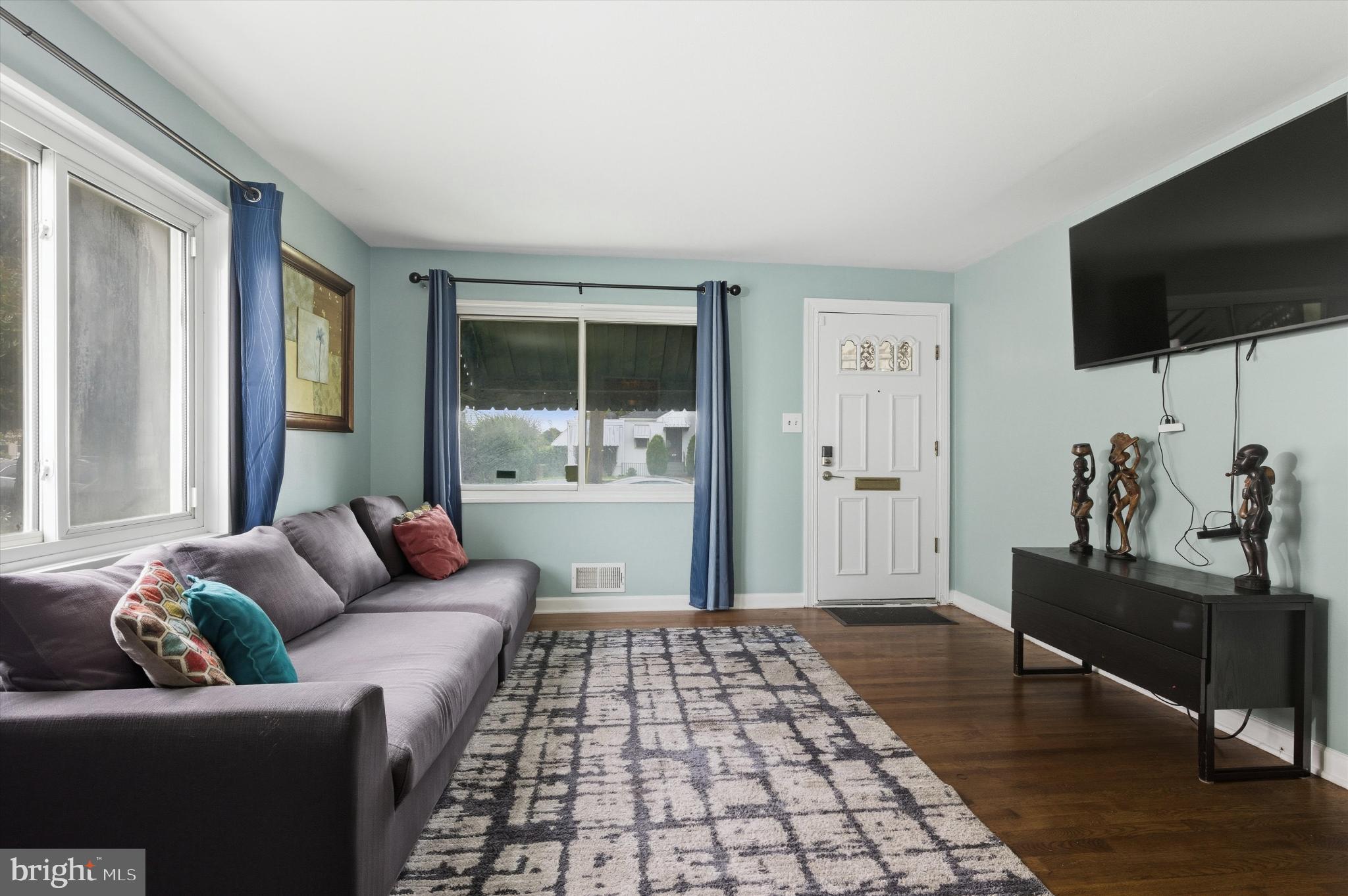 5024 Addison Road Capitol Heights, MD 20743 - Photo 6 of 23 a living room with furniture and a flat screen tv