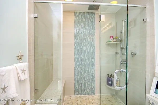 a spacious bedroom with a bed and a flat screen tv