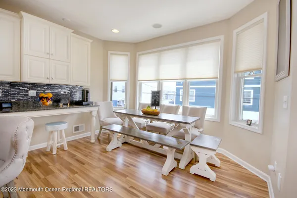 a living room with furniture a rug and a floor to ceiling window