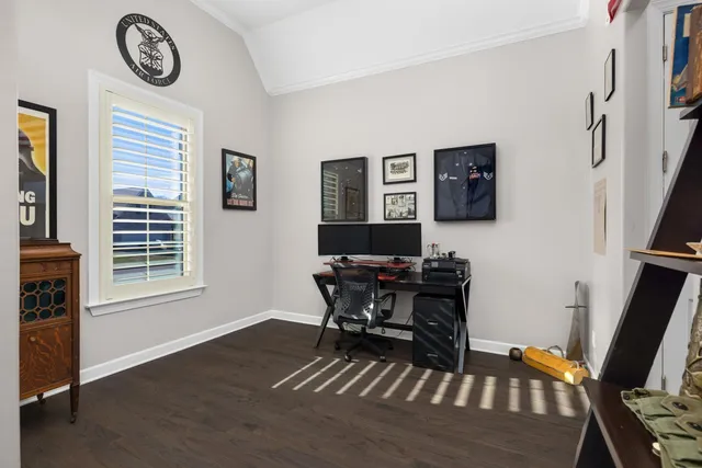 a view of a workspace with furniture and a window