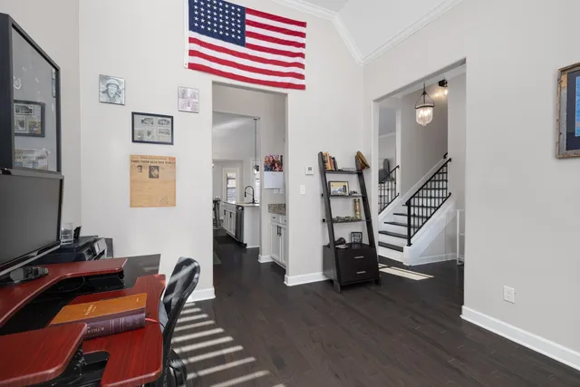 a view of a workspace with furniture and wooden floor