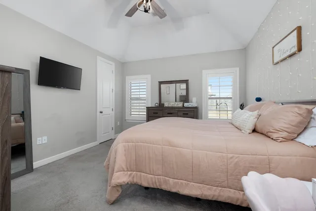 a bedroom with a large bed and a tv