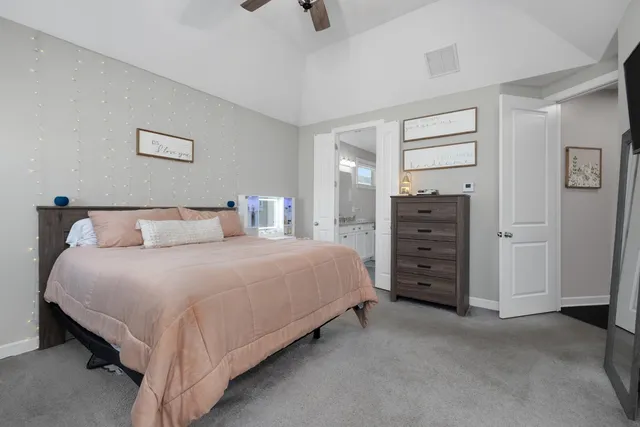 a bedroom with a bed and dresser