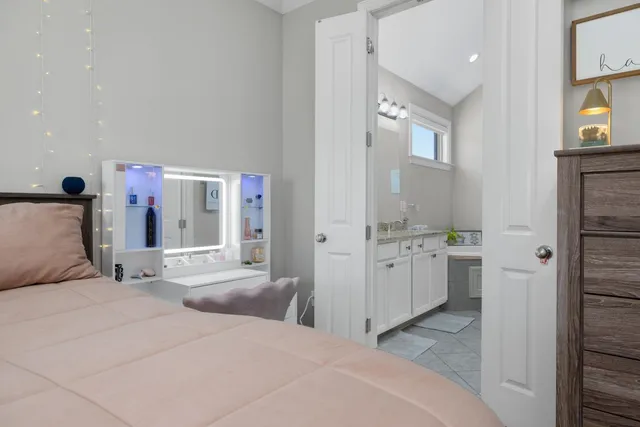 a bedroom with a bed and a mirror on dresser