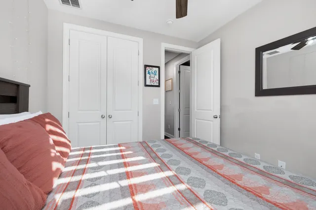 a bedroom with a bed and a painting on the wall