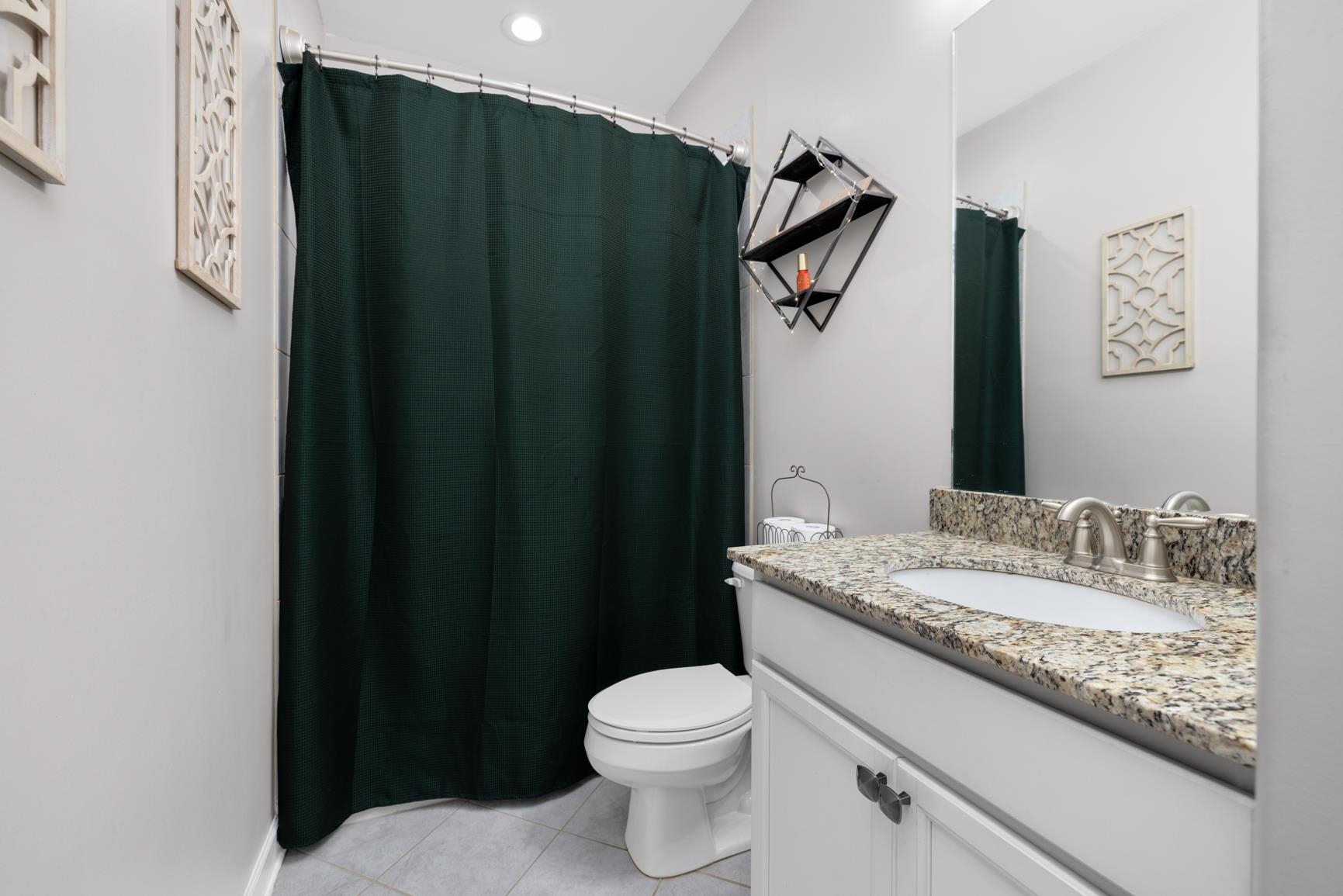 235 Misty Fields Road Oakland, TN 38060 - Photo 31 of 40 a bathroom with a granite countertop shower and a toilet