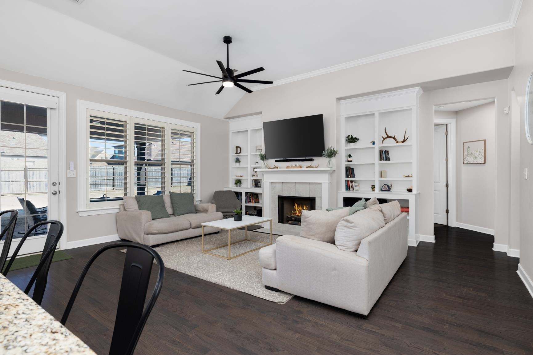 235 Misty Fields Road Oakland, TN 38060 - Photo 9 of 40 a living room with furniture a fireplace a flat screen tv and a large window