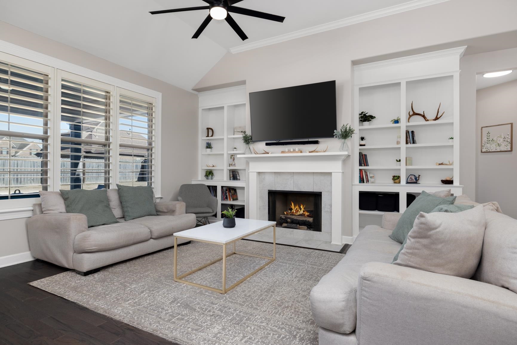 235 Misty Fields Road Oakland, TN 38060 - Photo 10 of 40 a living room with furniture a flat screen tv and a fireplace