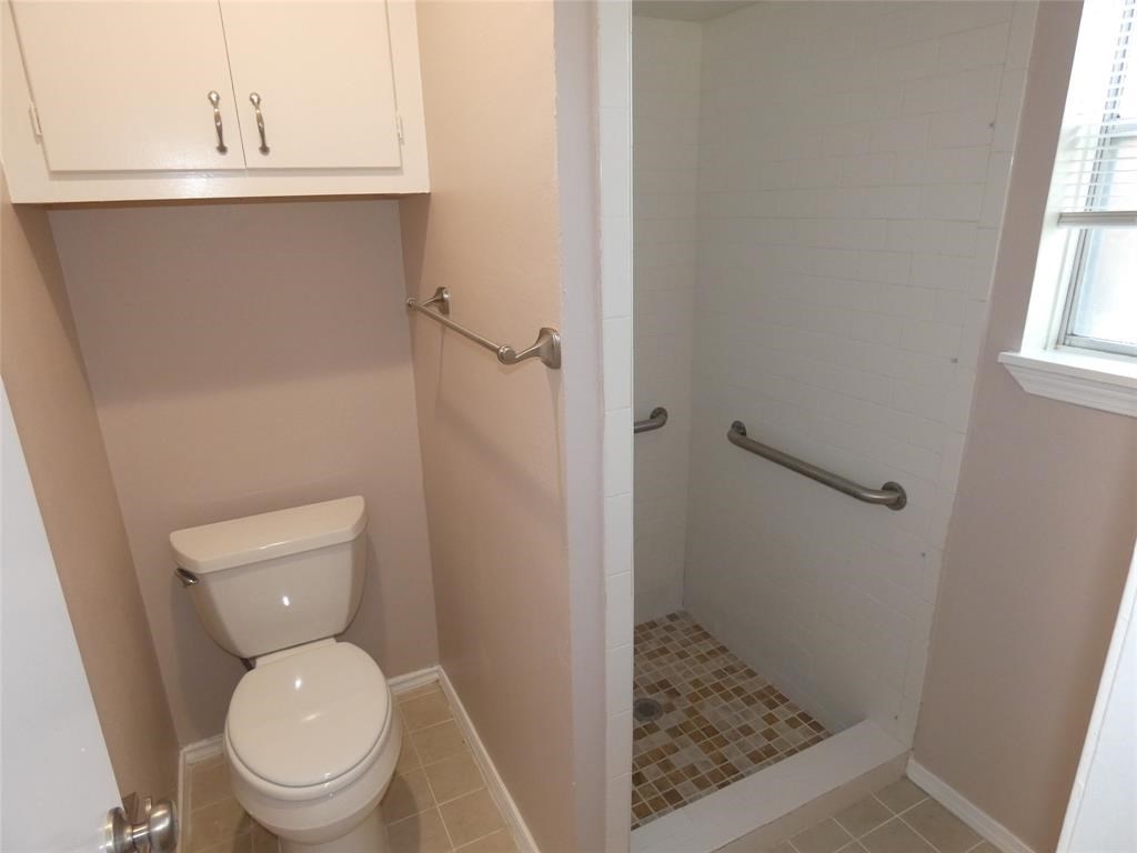 3406 Rockyridge Drive Houston, TX 77063 - Photo 11 of 13 a bathroom with a granite countertop toilet and a sink