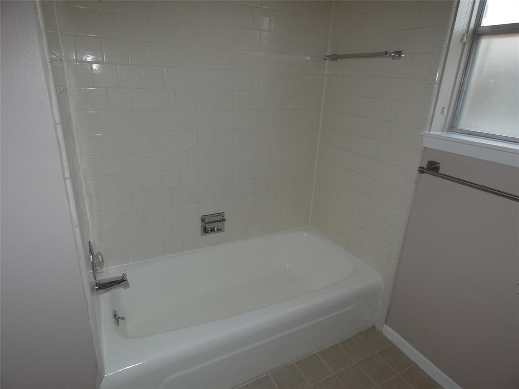3406 Rockyridge Drive Houston, TX 77063 - Photo 8 of 13 a close up of a bathtub in a bathroom