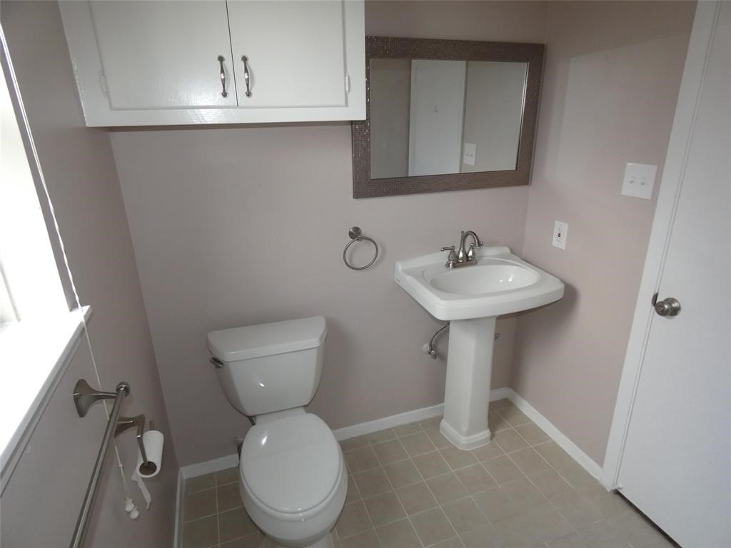 3406 Rockyridge Drive Houston, TX 77063 - Photo 9 of 13 a bathroom with a toilet sink and mirror