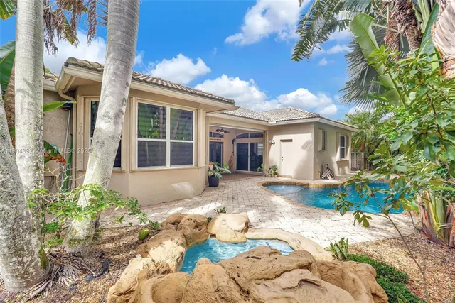 a front view of a house with a yard and chandelier