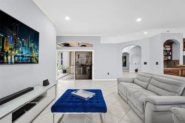a living room with couches and a flat screen tv