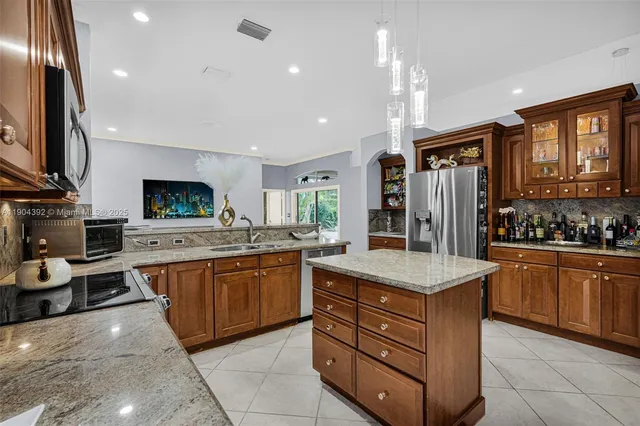 a kitchen with lots of counter top space and stainless steel appliances