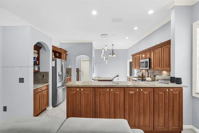 a kitchen with stainless steel appliances granite countertop a sink stove and cabinets