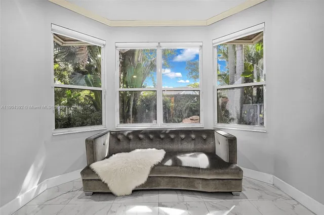 a view of a livingroom with workspace and a window