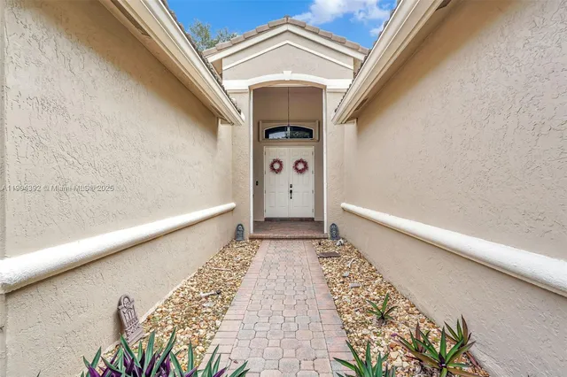 a view of a dining room with furniture and a potted plant