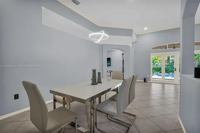 a living room with furniture and view of kitchen