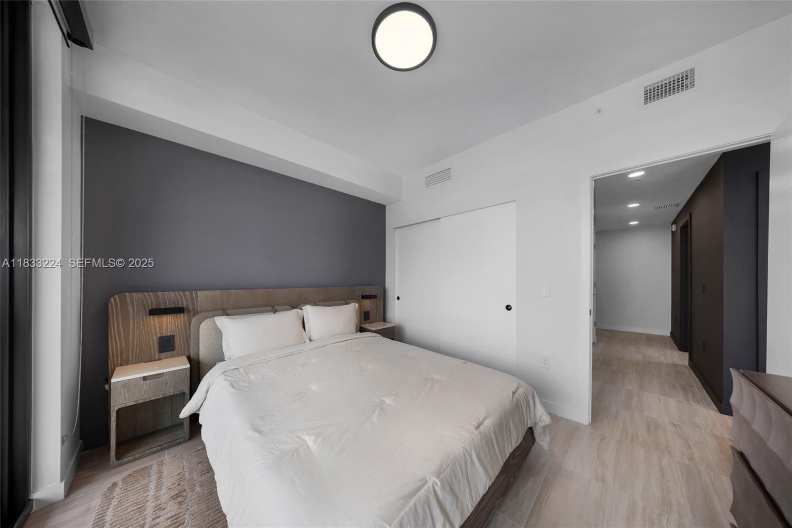 580 72nd Street, Unit 910 Miami Beach, FL 33141 - Photo 56 of 60 a bedroom with bed and wooden floor