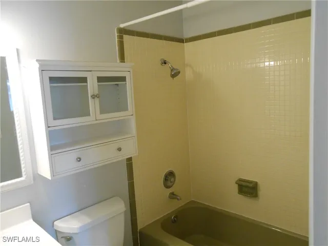 a bathroom with a toilet and shower