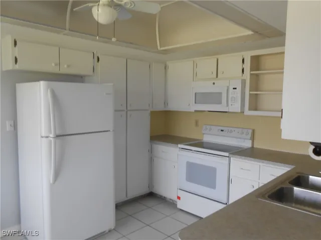 a kitchen with a stove and a refrigerator