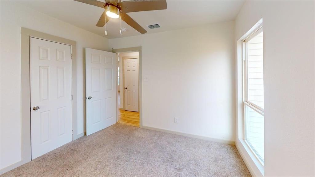 2554 Marfa Avenue Dallas, TX 75216 - Photo 15 of 19 Unfurnished bedroom featuring light carpet and a ceiling fan