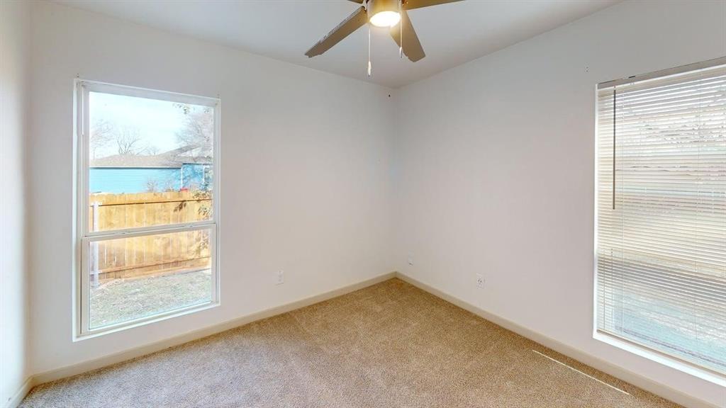 2554 Marfa Avenue Dallas, TX 75216 - Photo 16 of 19 Empty room with light colored carpet and ceiling fan