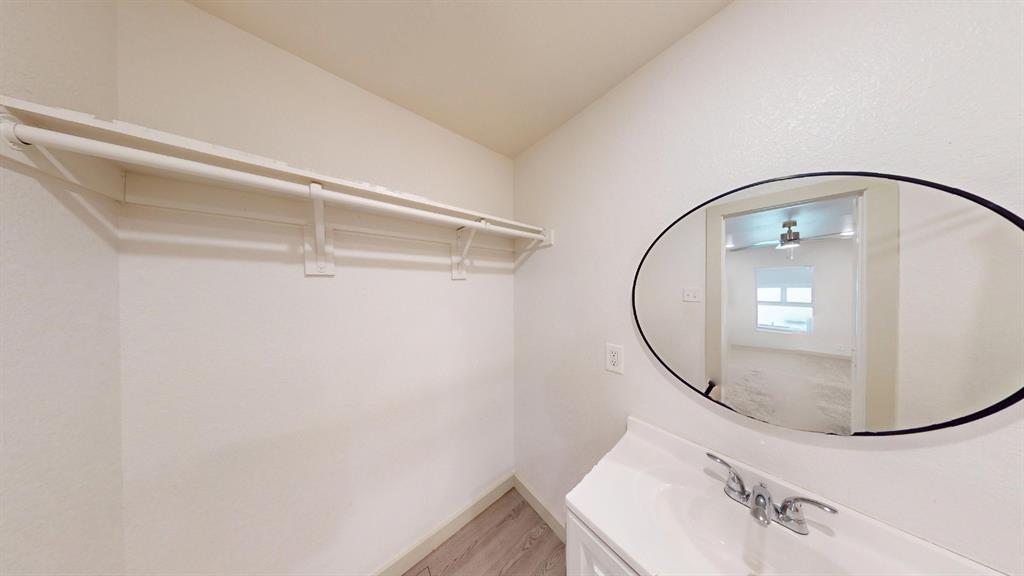 2554 Marfa Avenue Dallas, TX 75216 - Photo 17 of 19 Bathroom featuring vanity and light wood-style flooring